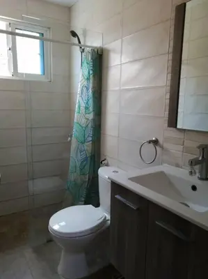 a bathroom with a toilet and a sink at Rincón de Tranquilidad in Bayahibe