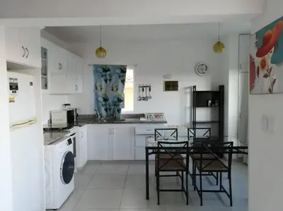 a kitchen with a table and chairs and a refrigerator at Rincón de Tranquilidad in Bayahibe