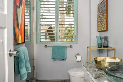 a bathroom with a sink and a toilet and a window at Renovated Condo at the Beach Close to Everything in Las Terrenas
