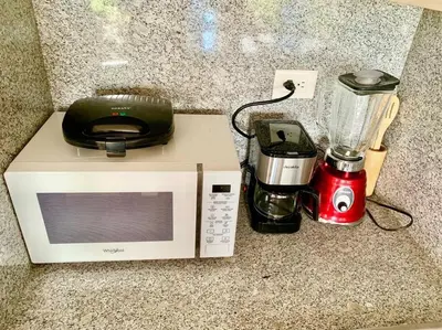 a microwave and a blender sitting on a counter at Vibe Gorgeous one bedroom apartment view beach in La Laguna