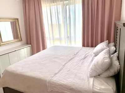 a bedroom with a bed with pillows and a window at Vibe Gorgeous one bedroom apartment view beach in La Laguna