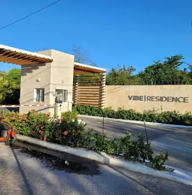 a motorcycle parked in front of a building with flowers at Gorgeous 2 bedroom apartment in Vibe Residence in Bayahibe