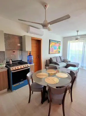 a kitchen and living room with a table and a couch at Gorgeous 2 bedroom apartment in Vibe Residence in Bayahibe
