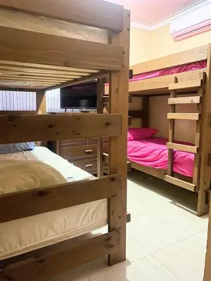 a bedroom with three bunk beds in a room at Apartamento de Relajacion in Los Paredones