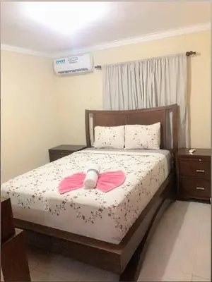 a bedroom with a bed with a pink bow on it at Confortable Apto de relajación in Los Paredones