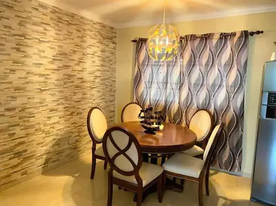 a dining room with a wooden table and chairs at Confortable Apto de relajación in Los Paredones