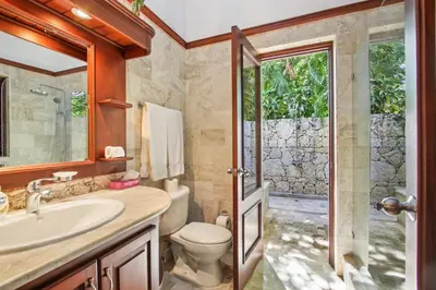 a bathroom with a toilet and a sink and a shower at Casa de Campo villa – Luxurious villa up to 12 people with pool jacuzzi golf in La Romana