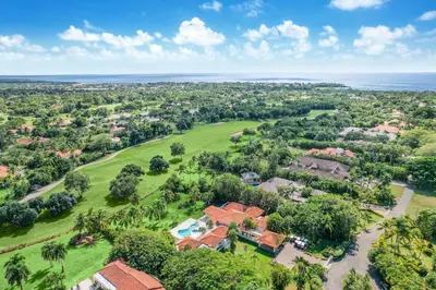 an aerial view of a house with a golf course and the ocean at Casa de Campo villa – Luxurious villa up to 12 people with pool jacuzzi golf in La Romana