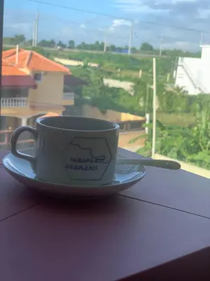 a coffee cup on a plate on a window sill at Samana Complexes Los Robles VII in Los Paredones