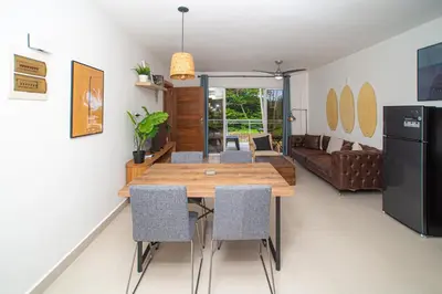 a kitchen and dining room with a wooden table and chairs at CMB202 BEACH AREA Res Cristamar in Eslabón