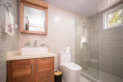 a bathroom with a toilet and a sink and a shower at CMB202 BEACH AREA Res Cristamar in Eslabón
