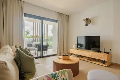 a living room with a couch and a flat screen tv at Sausalito | Relax Vista Piscina in Punta Cana