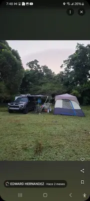 a tent and a car parked in a field at Camping in Cumayasa Kilómetros 4 1/2