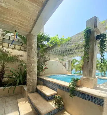 a swimming pool next to a resort at Villa Ruben Juan Dolio in Juan Dolio