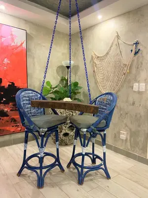 a swing with two chairs and a table in a room at Villa Ruben Juan Dolio in Juan Dolio