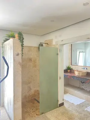 a bathroom with a green door in a room at Villa Ruben Juan Dolio in Juan Dolio