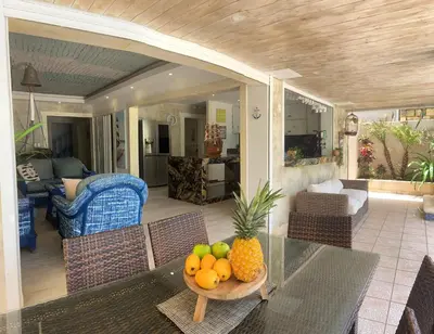 a living room with a table with a bowl of fruit at Villa Ruben Juan Dolio in Juan Dolio