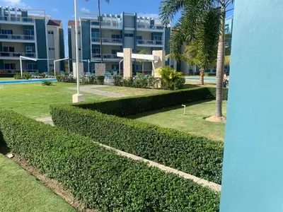 a row of hedges in front of a building at Apartamento tipo hotel WIFI - Estacionamiento in Punta Cana