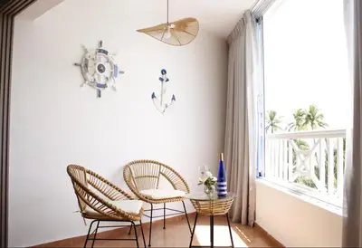 a room with two chairs and a table and a window at Albatros by R&R in Villas del Mar