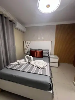 a bedroom with a bed with two towels on it at Apartamento Lujoso En San Pedro de Macoris in San Pedro de Macorís