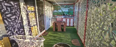 a balcony with a green floor and a fence at BlueEcolandia Bungalow TIERRA in Jarabacoa