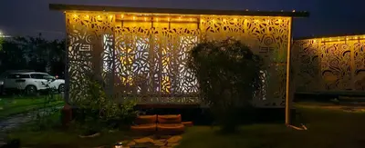 a building with a fence with lights on it at BlueEcolandia Bungalow TIERRA in Jarabacoa