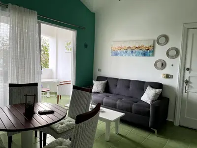 a living room with a couch and a table at Apto CGM Esmeralda in Bayahibe