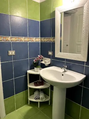 a bathroom with a sink and a mirror at Apto CGM Esmeralda in Bayahibe