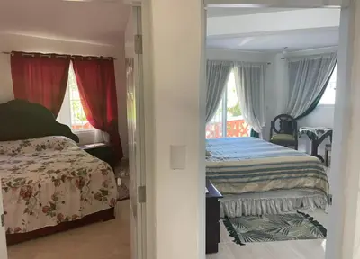 a bedroom with two beds and a window at Villa Fiordalisa in San Felipe de Puerto Plata