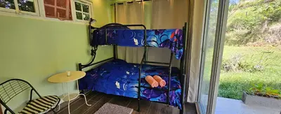 a room with a bunk bed in a room with a window at Rincón de Paz in Jarabacoa