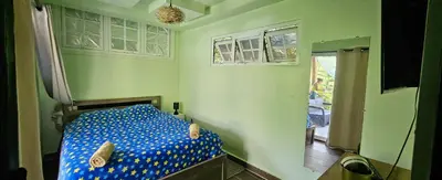a bedroom with a bed with blue polka dot sheets at Rincón de Paz in Jarabacoa