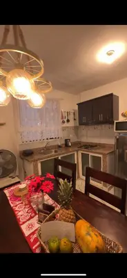 a kitchen with a table with fruit on it at Fantástico con luz aire tv y cocina in La Romana
