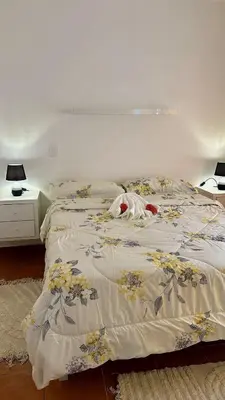 a bedroom with a bed with a blanket on it at Escapade Apartments in Cabarete
