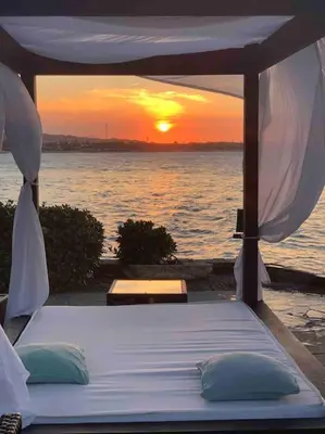 a bed in a tent with the sunset in the background at Velero Beach Cabarete 2 bedroom Penthouse in Cabarete