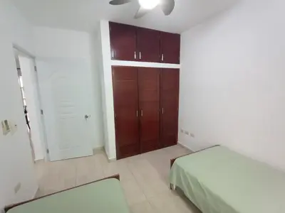 a bedroom with a bed and a closet in it at Apartamento Oasis PUNTA CANA in Punta Cana