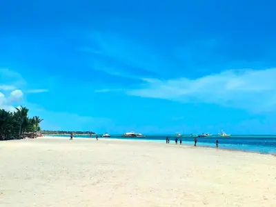 a group of people walking on the beach at Apartamento Oasis PUNTA CANA in Punta Cana