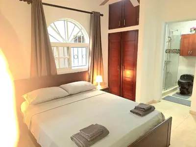 a bedroom with a bed with two towels on it at Apartamento Oasis PUNTA CANA in Punta Cana