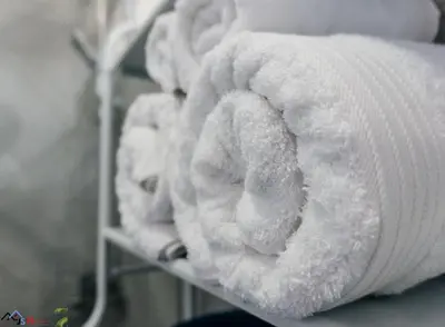 a row of white towels on a shelf at Caribey2 APT 2A3 in Las Terrenas