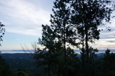 a view from the top of a mountain with trees at Nomad Dome at Salto Jimenoa Waterfall in Jarabacoa