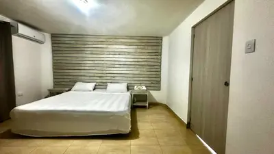 a bedroom with a large white bed in a room at Colina Buena Vista A5 in Jarabacoa
