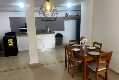 a kitchen and dining room with a table and chairs at Colina Buena Vista A5 in Jarabacoa