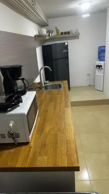 a kitchen with a sink and a microwave on a counter at Colina Buena Vista A5 in Jarabacoa