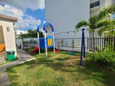 a playground in a yard next to a house at Cama king, piscina 3 habitacines in Santiago de los Caballeros