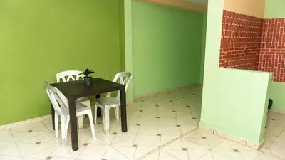 a table and chairs in a room with green walls at Casa de 2 Habitaciones in Los Frailes