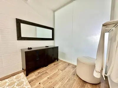 a bathroom with a tub and a sink and a mirror at Luxury 1 Bedroom with Seaview Seawinds in Cabarete