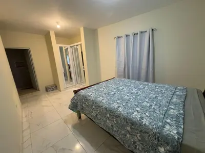 a bedroom with a bed and a large window at HEA Stays II in San Felipe de Puerto Plata