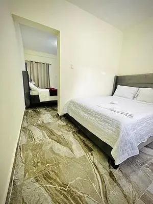 a bedroom with a bed with a marble floor at New hotel neo in Santa Cruz de Barahona