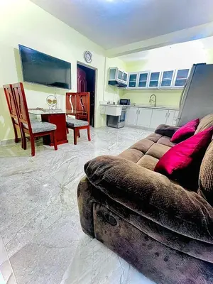 a living room with a couch and a kitchen at New hotel neo in Santa Cruz de Barahona