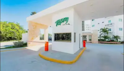 a large white building with a sign on it at Paraíso Tropical Juan Dolio in Villas del Mar