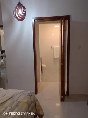 a bathroom with a door leading to a toilet at Paraíso Tropical Juan Dolio in Villas del Mar
